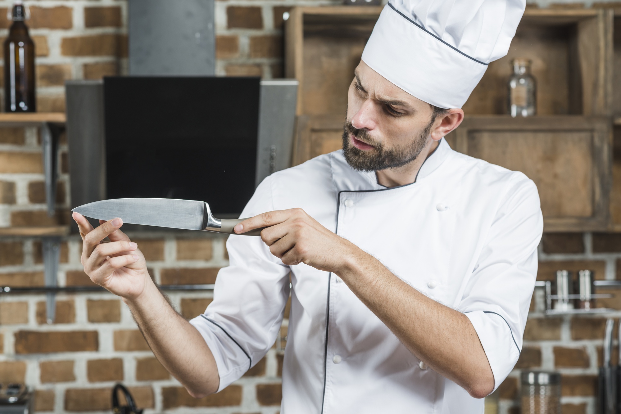 Chef demonstrating knife skills to a small class